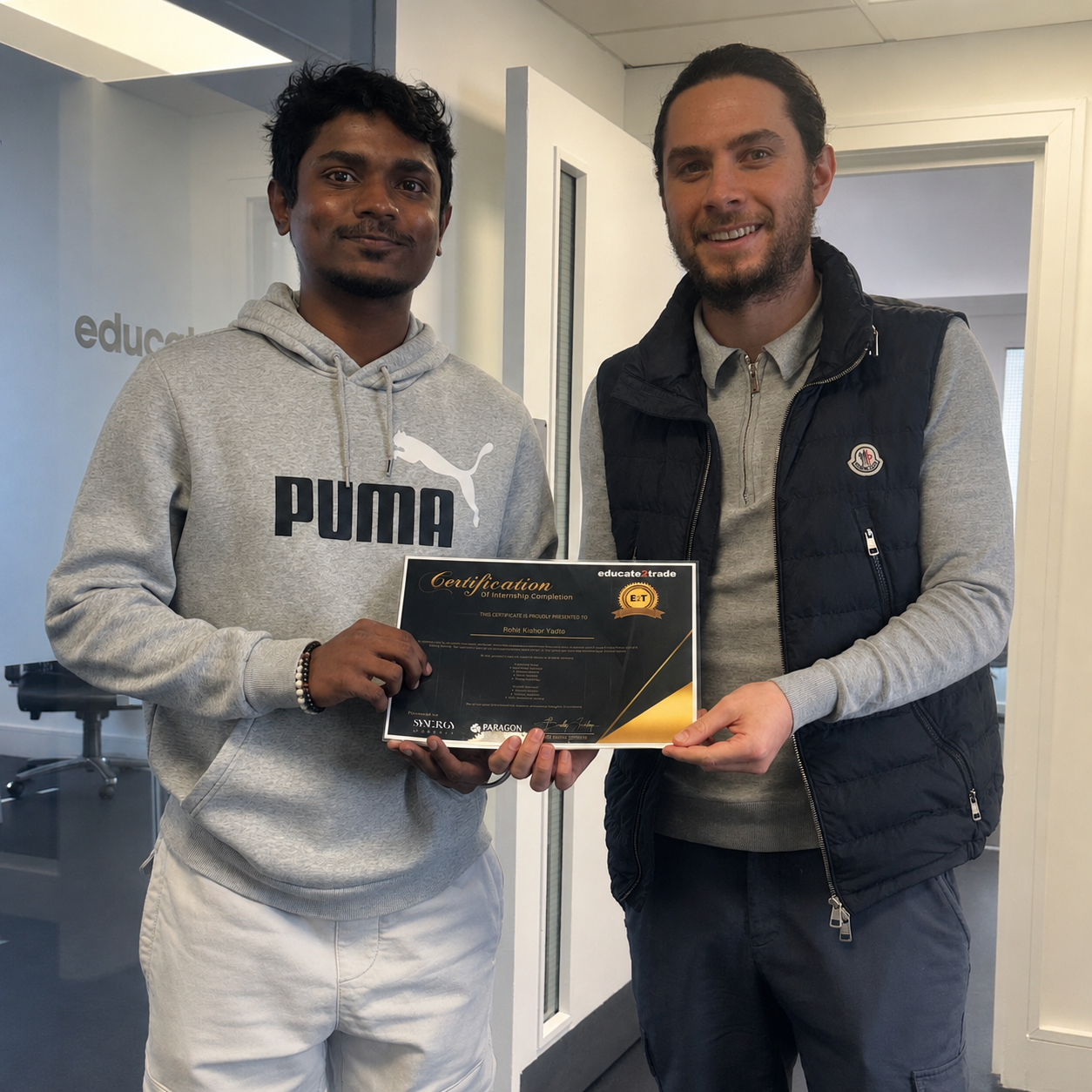 Sam Netto receiving their Educate2Trade certificate